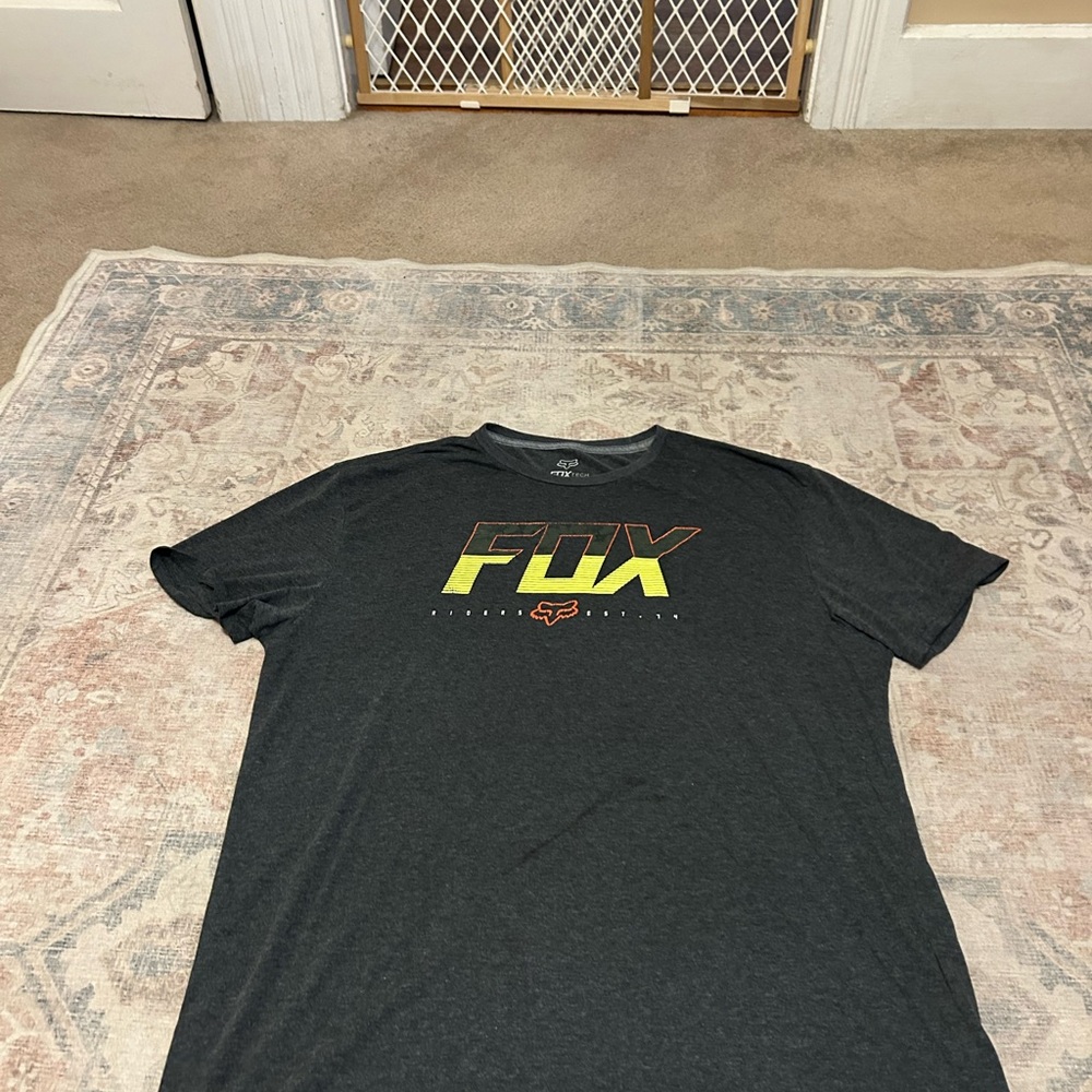 Fox Men's Black Tee with Yellow-Orange Gradient Logo